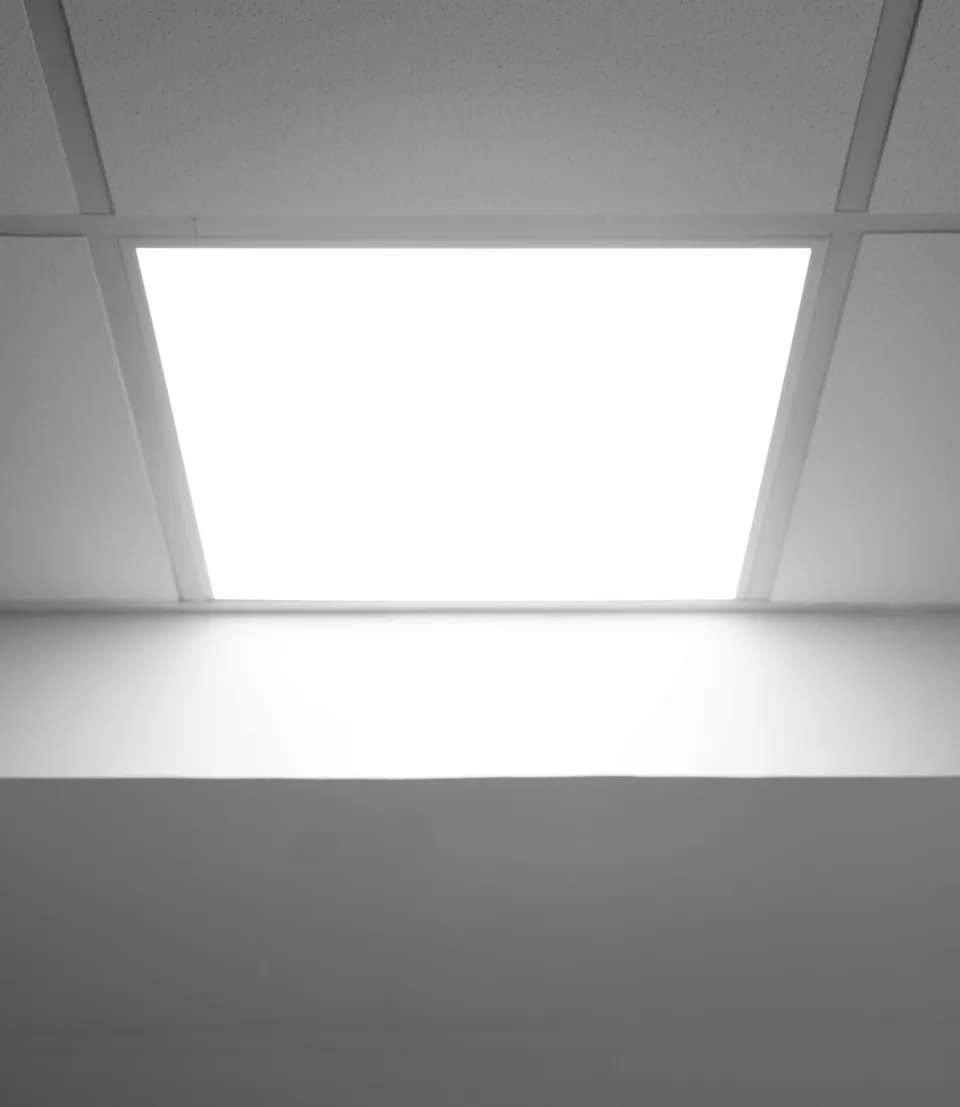 Illuminated rectangular panel fitted in a white suspended ceiling